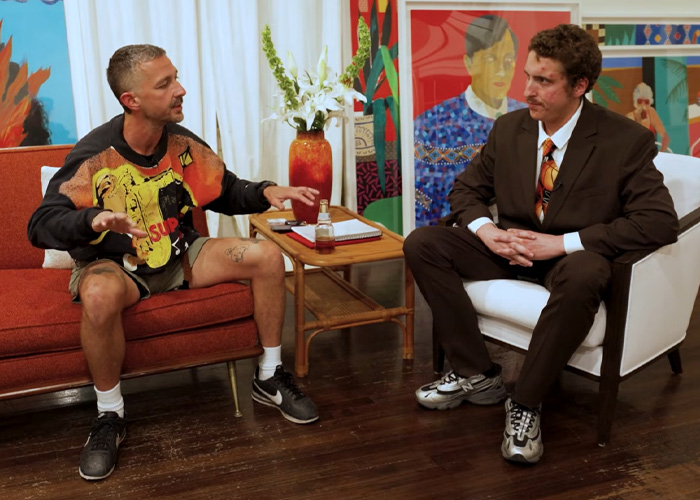 Shia LaBeouf seated during interview, discussing Mardi Gras arrest and revealing dark details about his mental health.