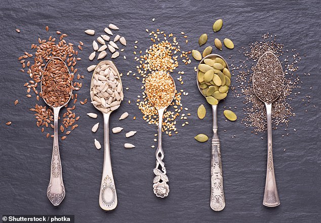 Pumpkin and chia seeds are shown above on the last two spoons on the right. They are alongside sesame seeds, flax seeds and sunflower seeds (stock image)