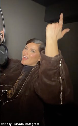 Her frock had a golden swirl pattern throughout the front, and she topped it with a matching moto-inspired bomber jacket