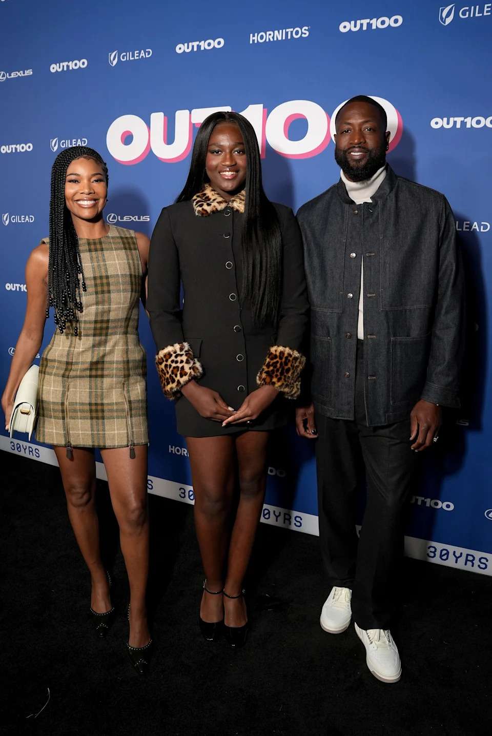 (L-R) Gabrielle Union, Zaya Wade and Dwyane Wade attend the Out100 Event 2024 at NeueHouse Hollywood on Dec. 11, 2024, in Hollywood, California.