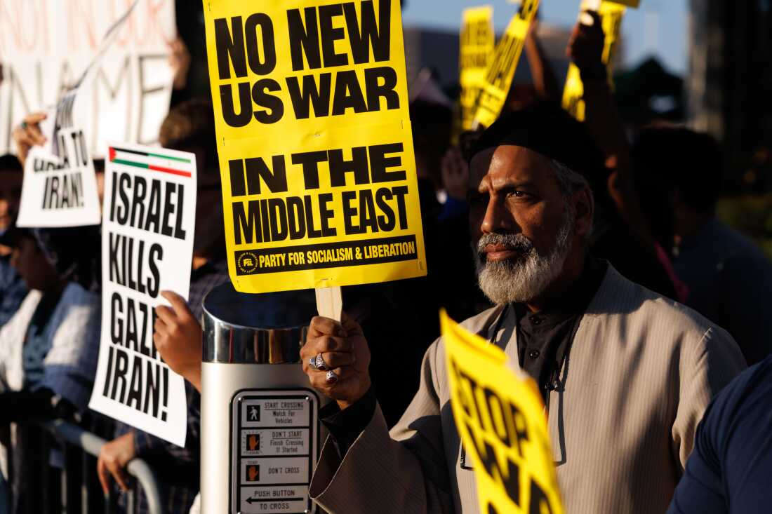 Demonstrators hold a sign reading "No New US War In The Middle East" during a protest against war in Iran in Houston, Texas, US, on Saturday, Feb. 28, 2026. Iran's supreme leader was killed in US-Israeli airstrikes, raising the stakes in a conflict that's spiraling across the oil-rich Middle East and disrupting traffic around the Hormuz shipping strait.