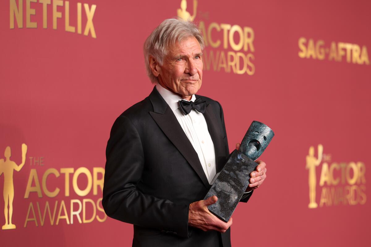 Harrison Ford holds his SAG-AFTRA Life Achievement Award.