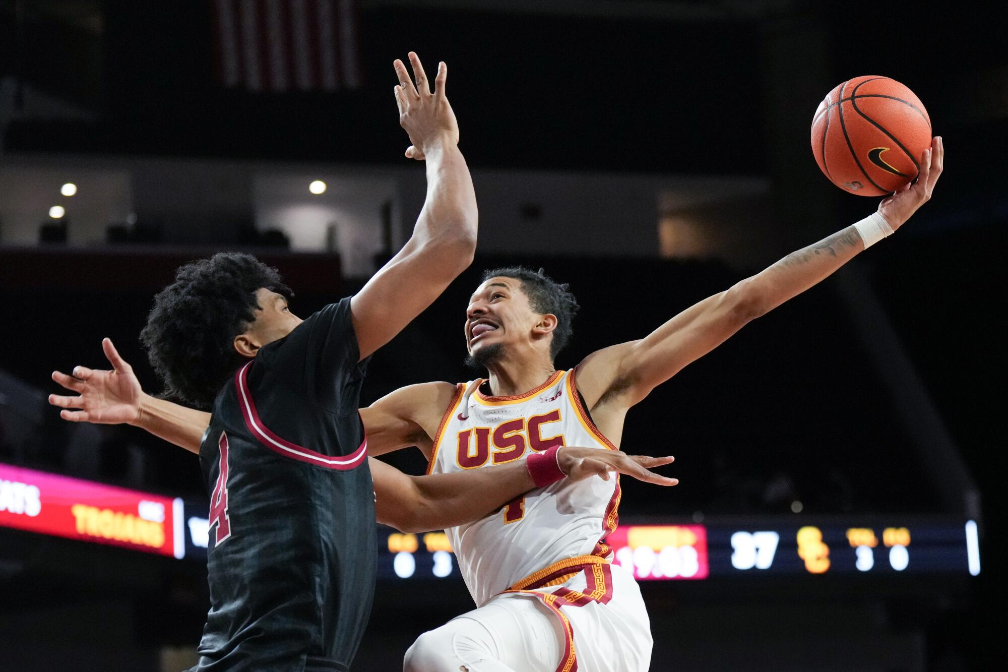 USC forward Chad Baker-Mazara goes up to dunk under pressure from Indiana forward Sam Alexis  at the Galen Center.