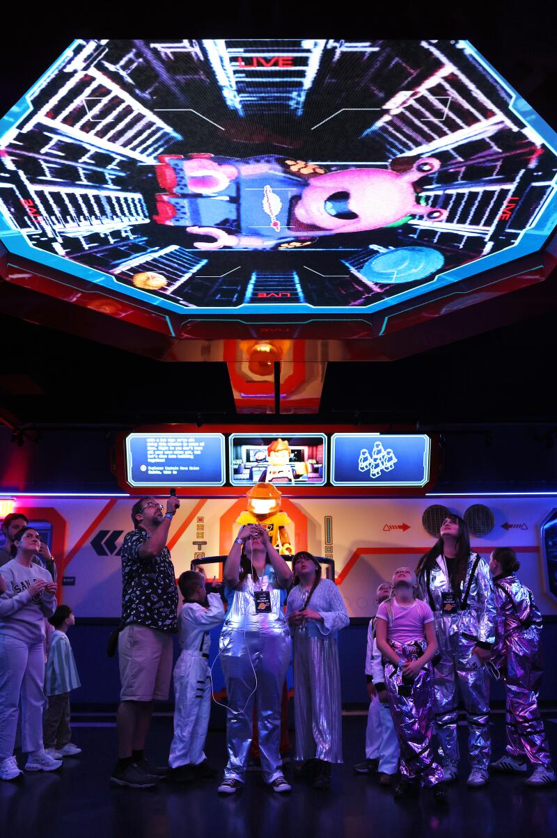 Visitors wait to ride the Galacticoaster.