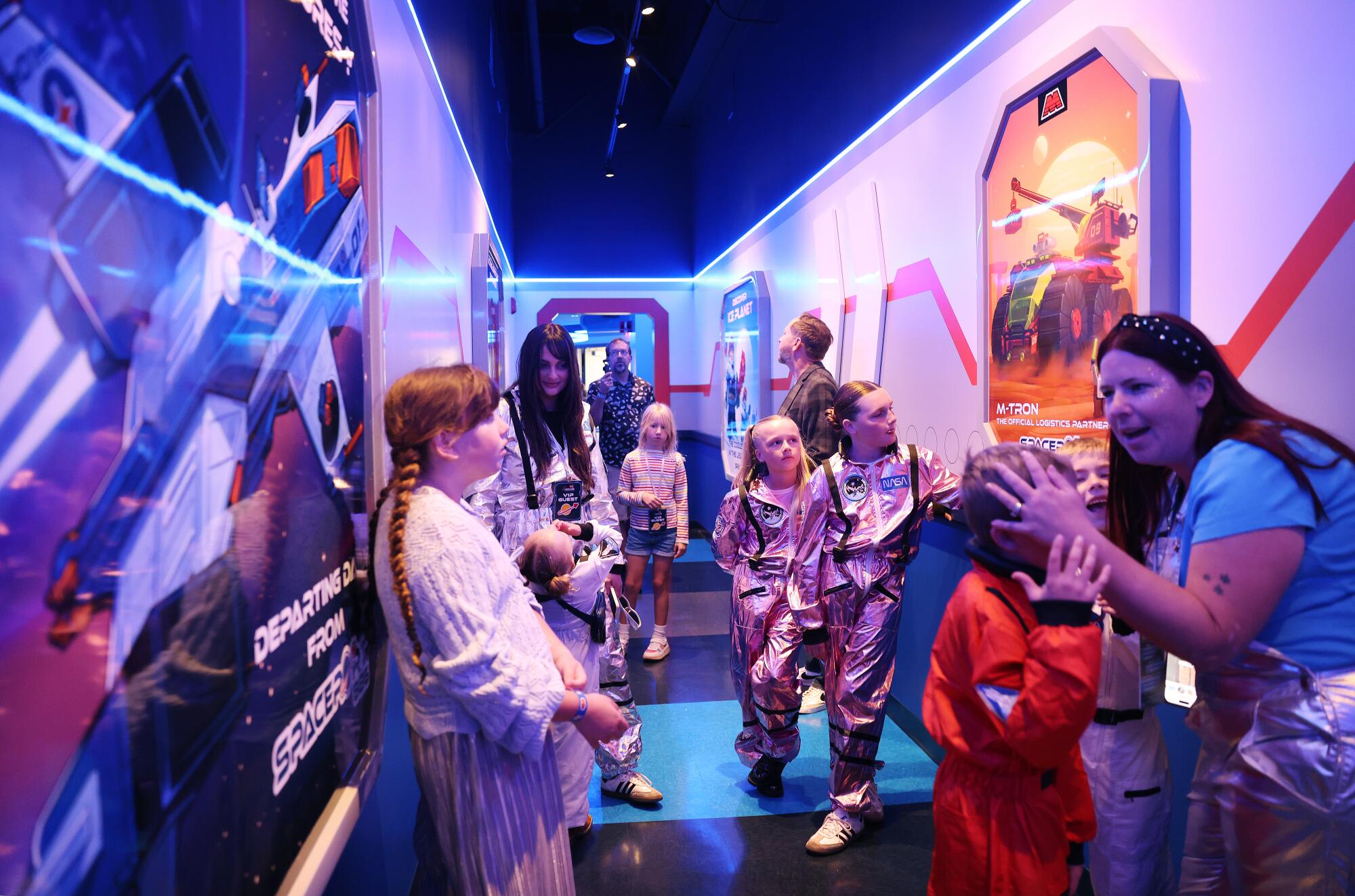 Visitors wait in line to ride the new indoor coaster at Legoland designed for families.