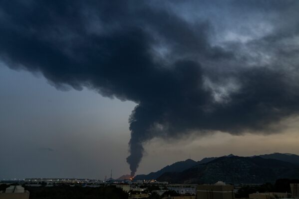 Fire and a plume of smoke is visible after, according to authorities, debris of an Iranian intercepted drone hit the Fujairah oil facility, in Fujairah, United Arab Emirates, March 3, 2026. (AP Photo/Altaf Qadri)