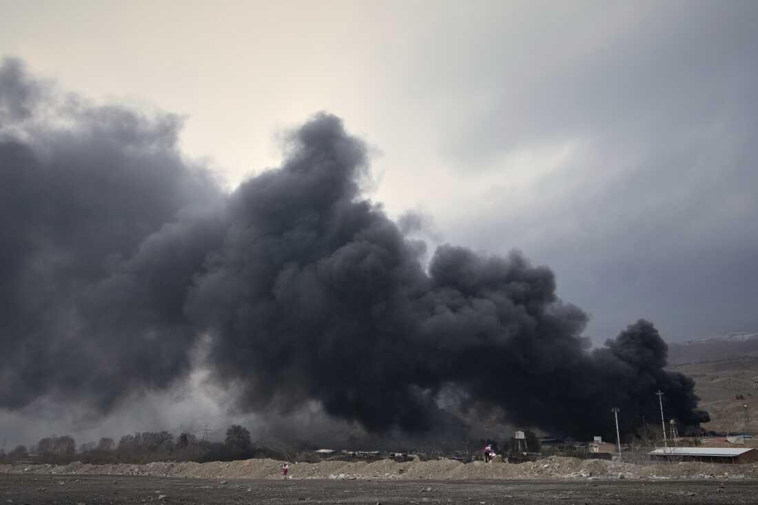 A thick plume of smoke rises from an oil storage facility hit by a U.S.-Israeli strike late Saturday in Tehran, Iran, Sunday, March 8, 2026.