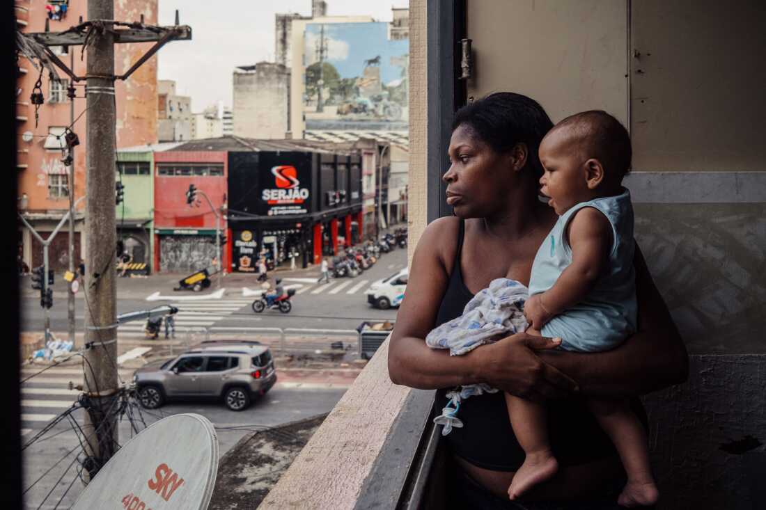 Janaina Xavier, a community leader, holds her son while looking out the window of the building where she lives with six of her 10 children in an occupation near the Cracolândia district in São Paulo, Brazil, on April 23, 2024. She currently serves as a council member for the Coordination of Policies for the Homeless Population and advocates for the rights of people living in and around Cracolândia, one of the city’s most stigmatized areas. I chose this image because it reflects how women living in marginalized urban spaces are shaping public policy and grassroots resistance. Janaina Xavier’s leadership connects motherhood, community organizing and political advocacy in one of São Paulo’s most contested territories. This image has not been previously published and was not produced with grant funding.