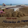 Indian sand artist Sudersan Pattnaik gives final touches on a sand sculpture with a message of prayers for the missing Malaysian Airlines Flight MH370 at Puri Beach on March 9, 2014.