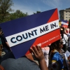 Protesters hold signs saying “COUNT ME IN” at a 2019 rally against the Trump administration’s push for a census citizenship question outside the U.S. Supreme Court in Washington, D.C.
