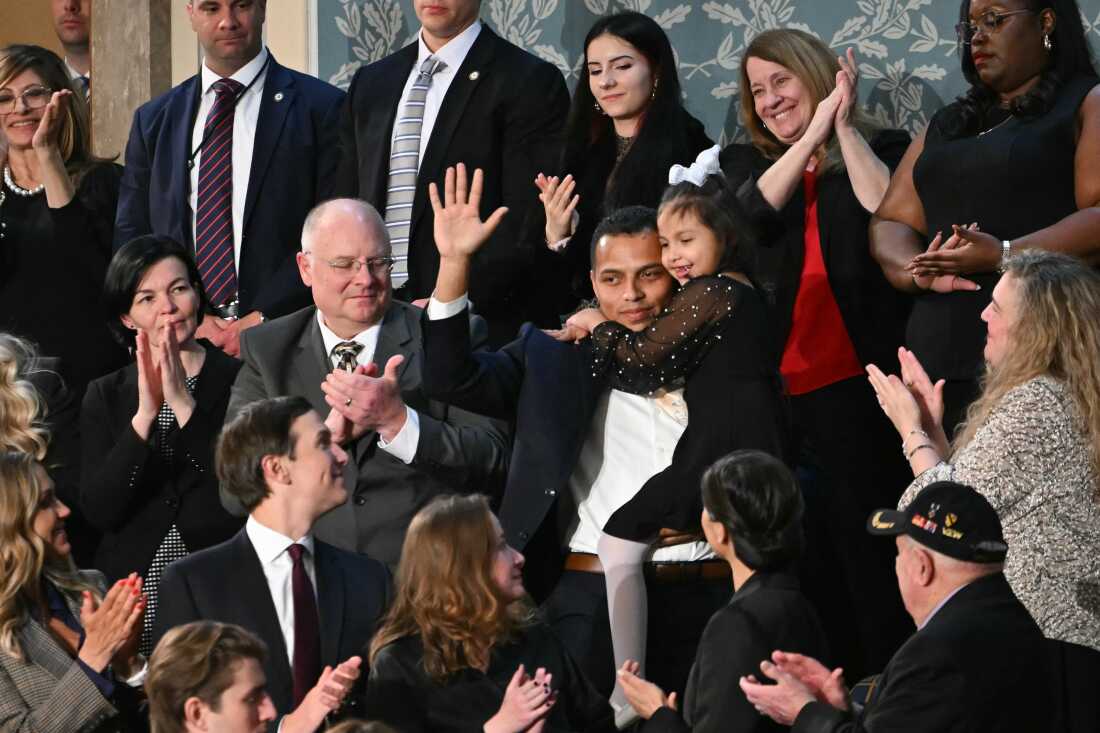 Seven-year-old Dalilah Coleman, who was critically injured in a car accident allegedly caused by a truck driver who was in the country illegally, is held by her father Marcus Coleman as they are recognized by President Trump as he delivers the State of the Union address in Washington, D.C., on February 24, 2026.