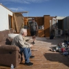 People in the remnants of a home in London, Kentucky after it was hit by a tornado in May 2025. Home insurance costs are expected to increase this year in states that have suffered hail and tornado damage from big convective storms.