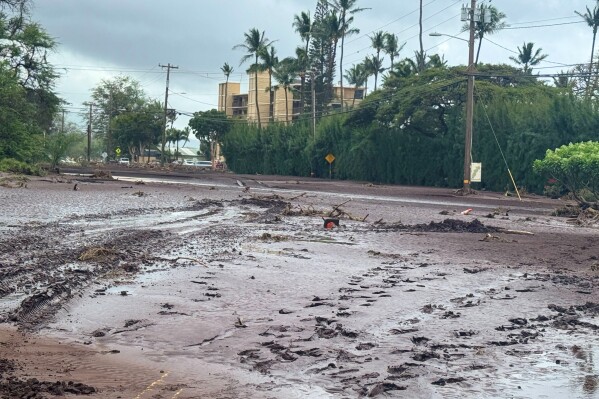 Mud is covers a street following heavy rains and flooding on the island of Maui, Sunday, March 15, 2026, in the community of North Kihei, Hawaii. (Athena Walsh via AP)