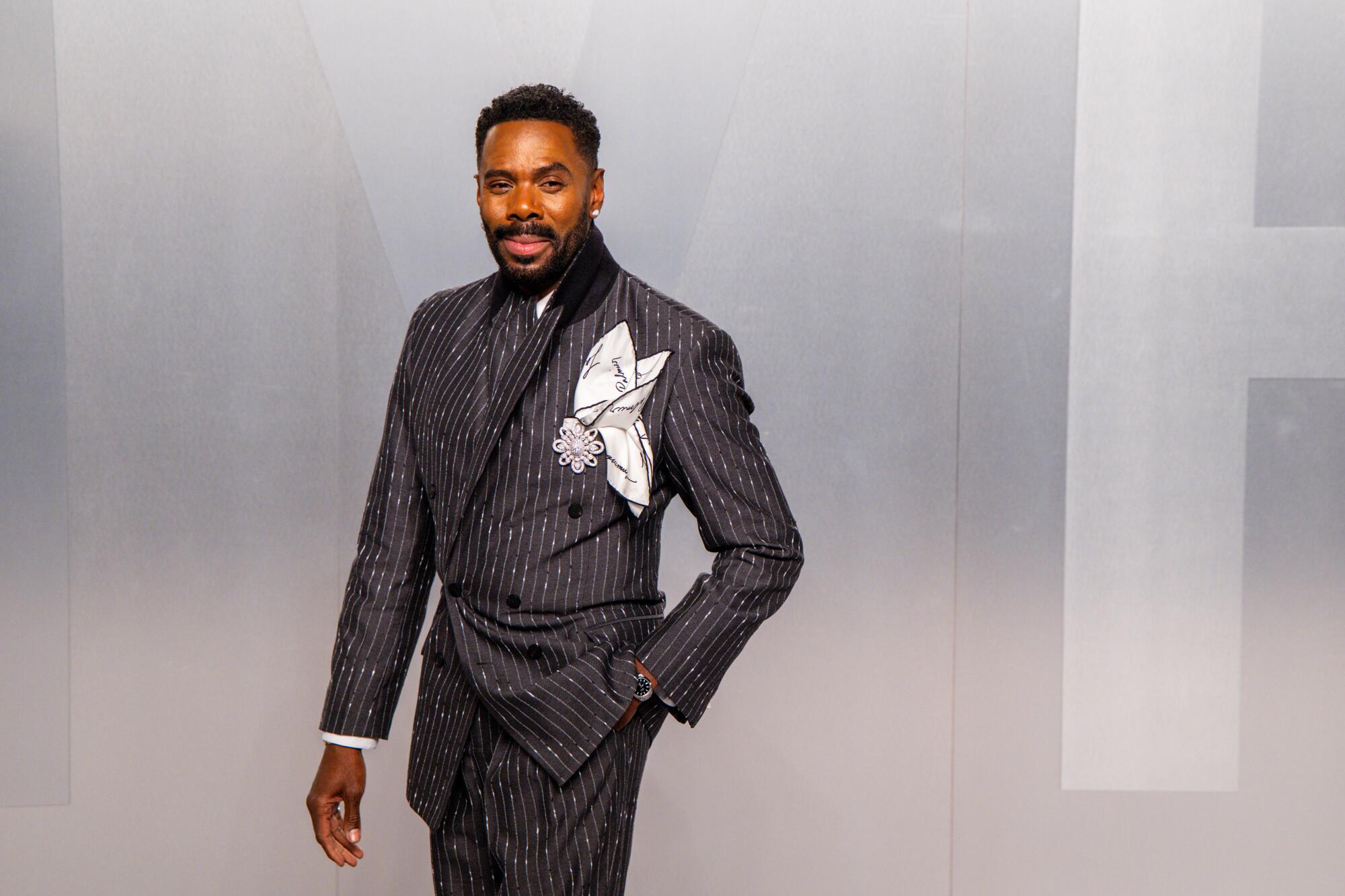 Colman Domingo wears a pinstripe suit. 