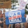 A demonstrator holds a sign that says “U.S. MAIL NOT FOR SALE” during an April protest in Columbia, S.C.