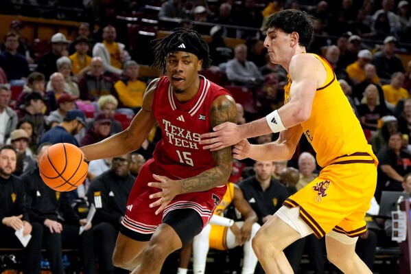 Texas Tech forward JT Toppin (15) drives against Arizona State forward Santiago Trouet during the first half of an NCAA college basketball game, Tuesday, Feb. 17, 2026, in Tempe, Ariz. (AP Photo/Rick Scuteri)