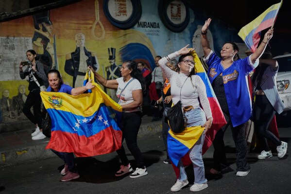 Venezuela fans celebrate their country's win against the United States in the championship match of the World Baseball Classic a day prior, in Caracas, Venezuela, Wednesday, March 18, 2026. (AP Photo/Ariana Cubillos)