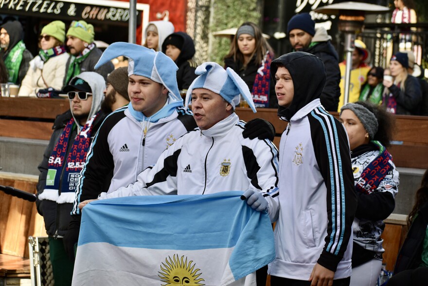 Argentina fans raise their flag during a Dec. 5, 2025, final draw announcement event for the FIFA World Cup at Kansas City’s Power and Light District.