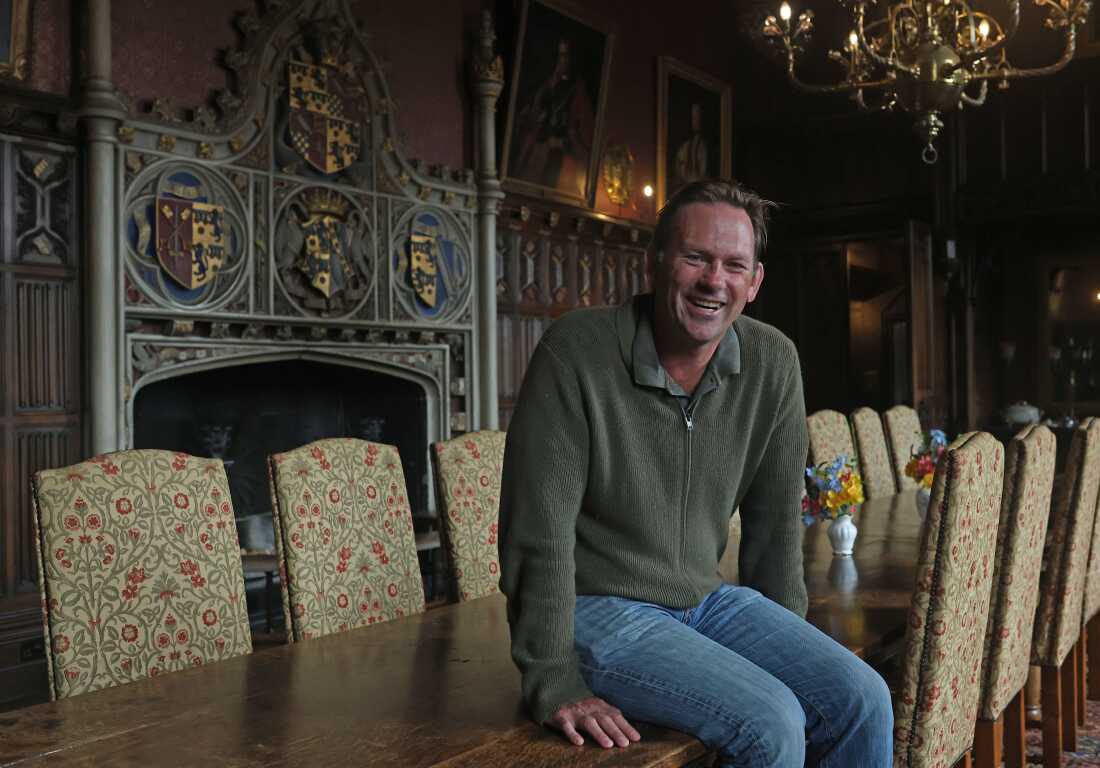 Aristocrat Charles Courtenay, 19th Earl of Devon, pictured alongside his family Coat of Arms.
