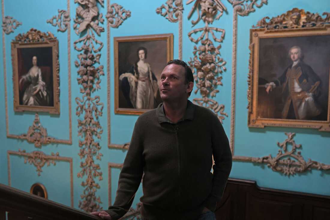 Aristocrat Charles Courtenay, 19th Earl of Devon, pictured alongside portraits of his ancestors at his family seat.