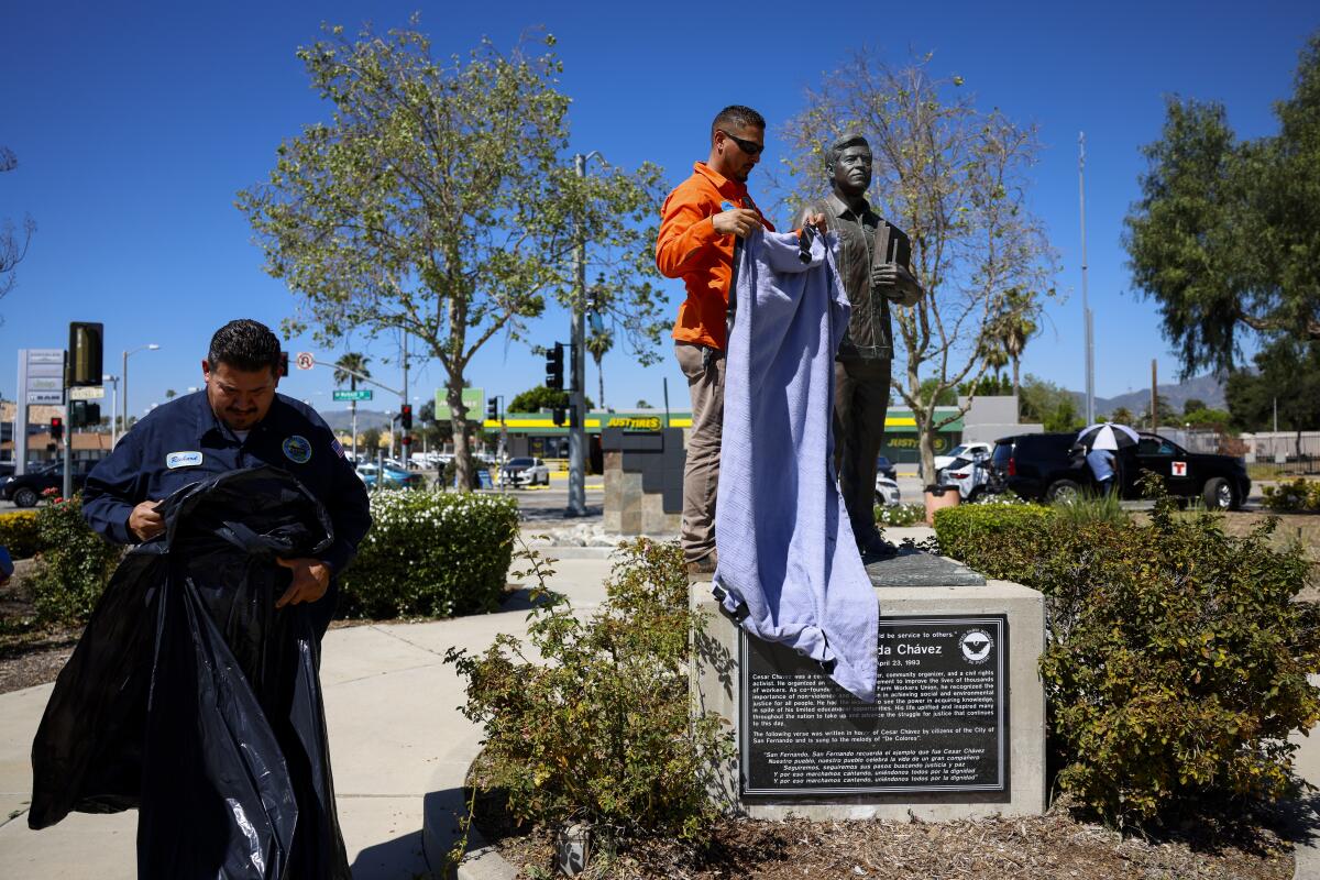 Public Works staff for the city of San Fernando cover the statue at the Cesar E. Chavez Memorial Park 