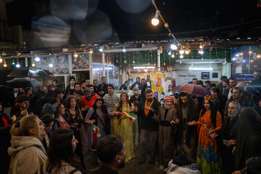 A group of people dance in the center of Akre in celebration of Nowruz.