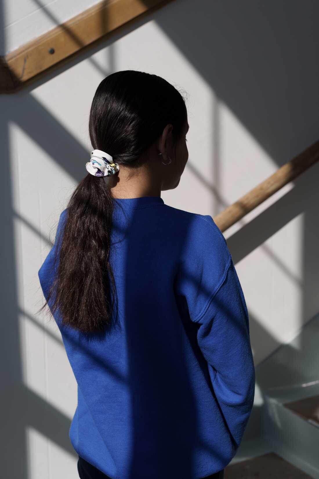 Ellah, the daughter of the principal and a student at the school, stands for a portrait in St. Paul, Minn., on March 18. 