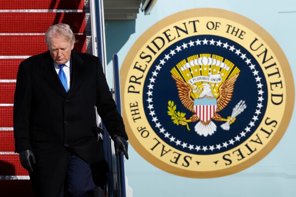 President Donald Trump walks down the stairs of Air Force One upon his arrival at Joint Base Andrews, Md., Monday, March 23, 2026. (AP Photo/Luis M. Alvarez)