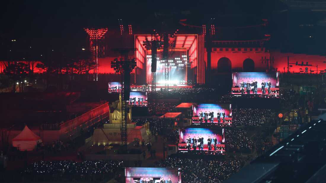 Fans of K-pop boy band BTS cheer during the BTS' comeback concert near the Gwanghwamun Square on March 21, 2026, in Seoul, South Korea. 