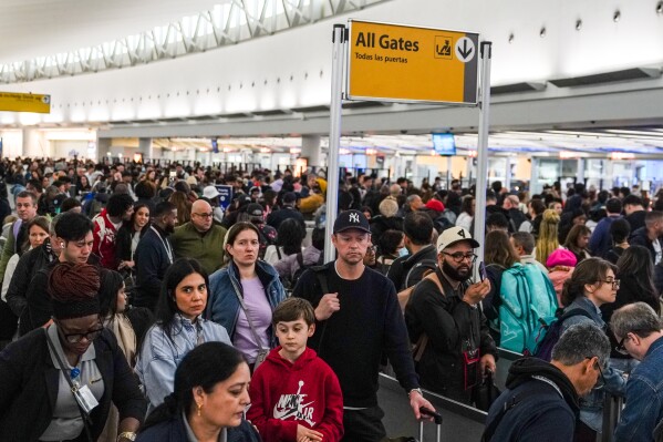 People wait in long TSA security lines at John F. Kennedy International Airport (JFK) in the Queens borough of New York, Monday, March 23, 2026. (AP Photo/Ryan Murphy)