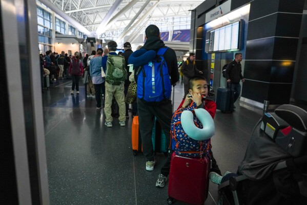 People wait in long TSA security lines at John F. Kennedy International Airport (JFK) in the Queens borough of New York, Monday, March 23, 2026. (AP Photo/Ryan Murphy)