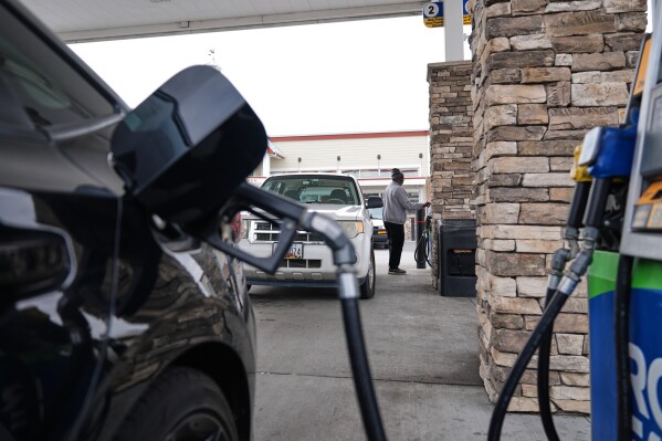 A person fuels their vehicle at a gas station March 19, 2026, in Baltimore. (AP Photo/Stephanie Scarbrough, File)