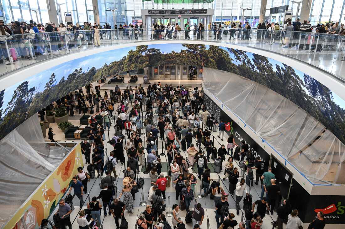 Travelers wait in long security lines at George Bush Intercontinental Airport in Houston, Texas, on Monday.