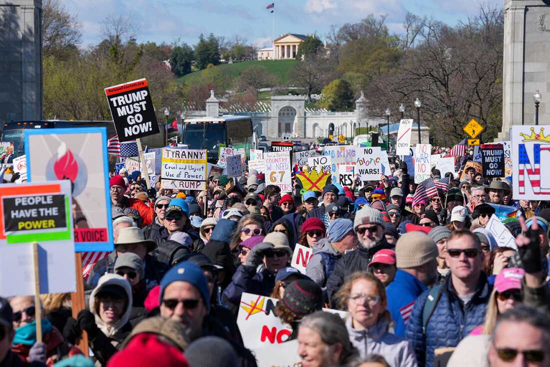 TOPSHOT - Demonstrators walk across the Memorial Bridge from Arlington, Virginia into Washington, DC, during the "No Kings" national day of protest on March 28, 2026. Nationwide protests against US President Donald Trump are expected Saturday as millions of people vent fury over what they see as his authoritarian bent and other forms of cruel, law-trampling governance. It is the third time in less than a year that Americans will take to the streets as part of a grassroots movement called "No Kings," the most vocal and visual conduit for opposition to Trump since he began his second term in January 2025. (Photo by Ken Cedeno / AFP via Getty Images)