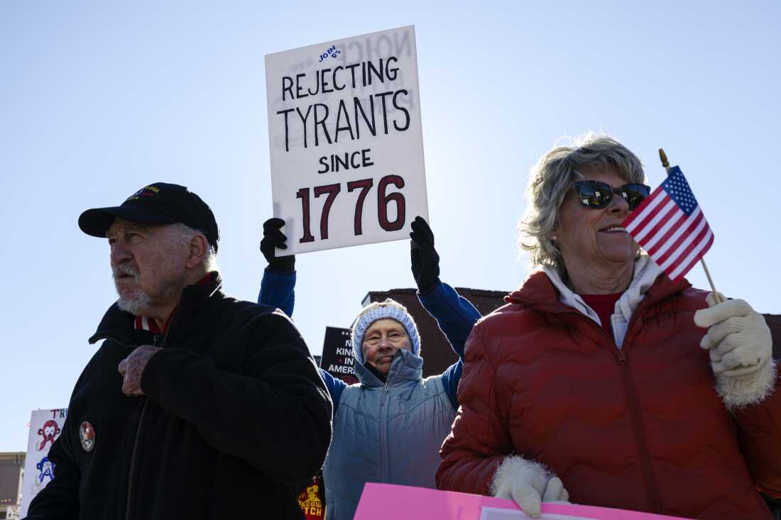 Demonstrators gather, holding signs near a roadside during a No Kings protest on March 28, 2026 in Shelbyville, Kentucky. This is the third nationwide "No Kings" protest held against the Trump administration. (Photo by Jon Cherry/Getty Images)