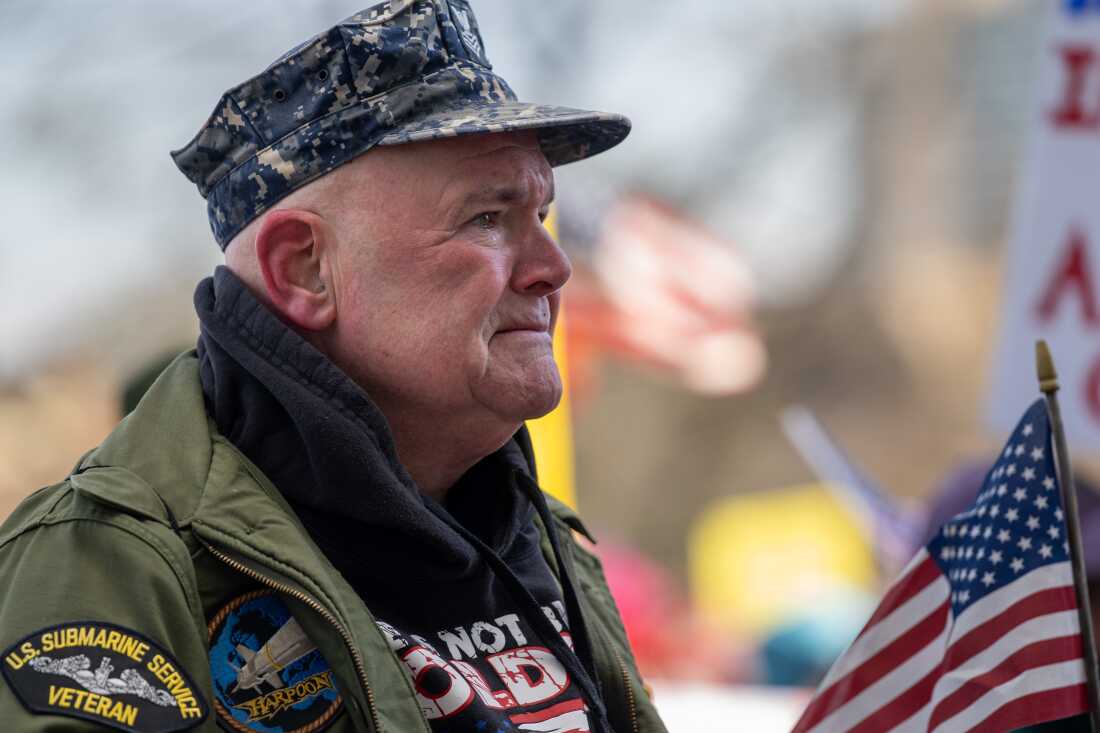 HARTFORD, CONNECTICUT, MARCH 28, 2026: Ken MacDonald tears up as he listens to a speech about the plight of his fellow veterans. “[Trump]’s playing with the lives of military people,” he said. Thousands rally at the “No Kings” protest at the capitol in Hartford on March 28, 2026. (Tyler Russell/Connecticut Public)