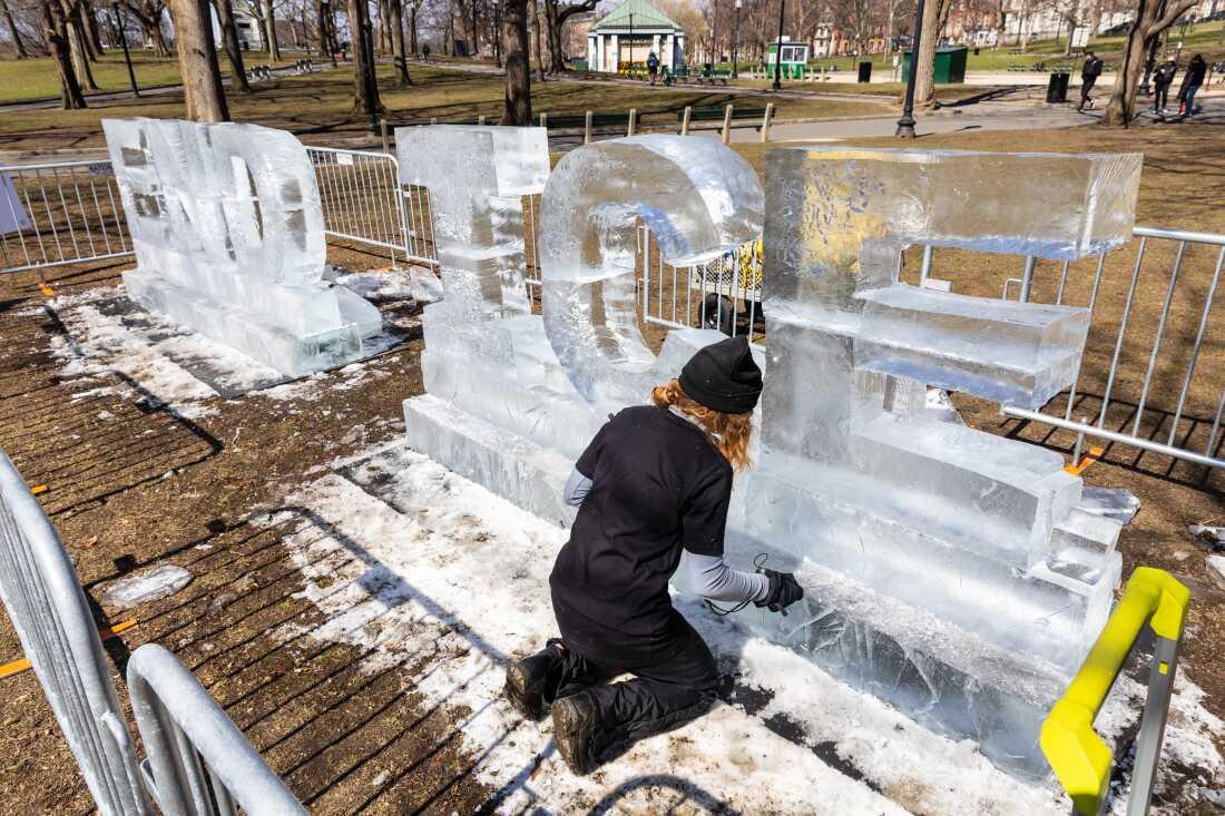 Kat Carves works on a ice sculpture that says ‘End Ice’ ahead of the No King rally in the Boston Common on Saturday, March 28, 2026.