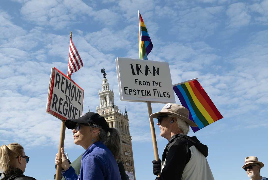 Maria Perry, at left, and John Stock joined protesters gathering in Mill Creek Park in Kansas City on Saturday, March 28, 2026 to oppose the actions of the Trump administration during nationwide No Kings demonstrations. (Photo credit Julie Denesha/KCUR)