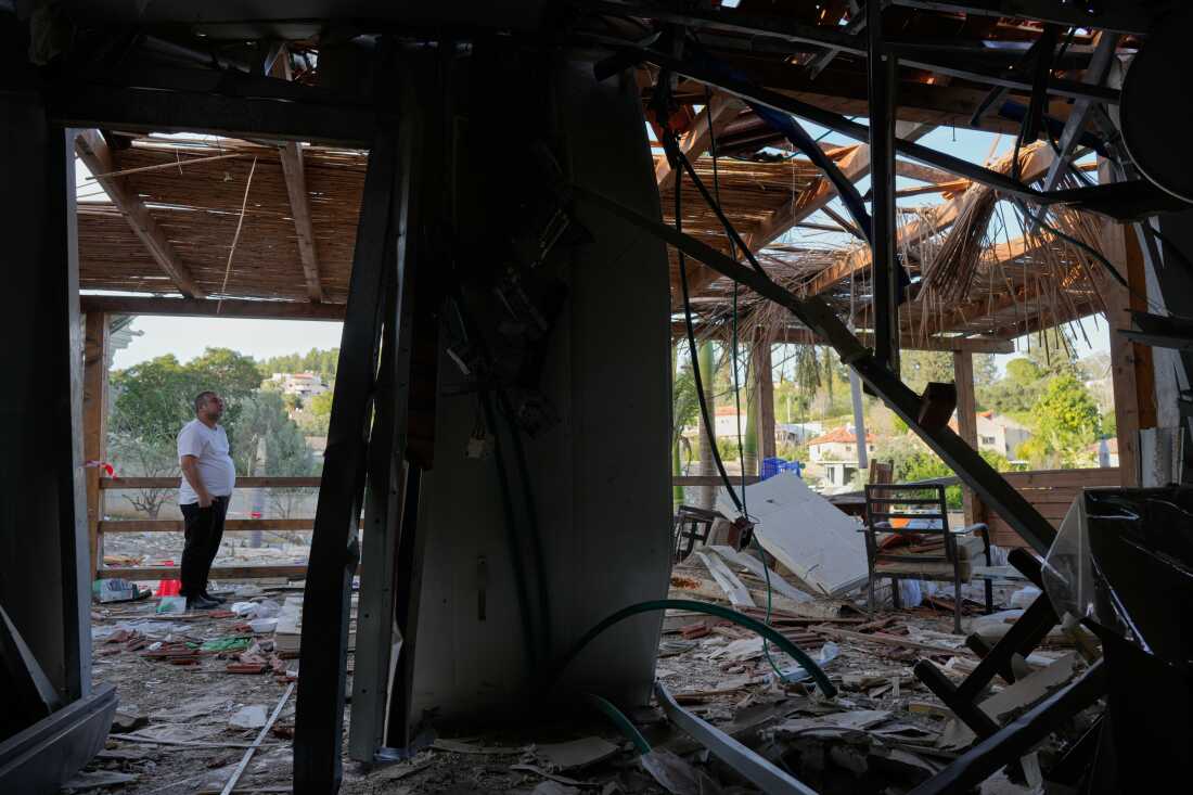 Residents inspect their home after it was struck by an Iranian missile in Eshtaol, central Israel, Saturday, March 28, 2026.
