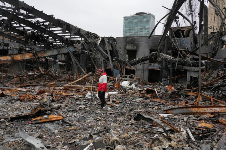 A member of the Iranian Red Crescent Society stands at Hypercar, an auto service center, amid damages which according to the company's officials were caused by strikes on March 1, in Tehran, Iran on March 28, 2026.