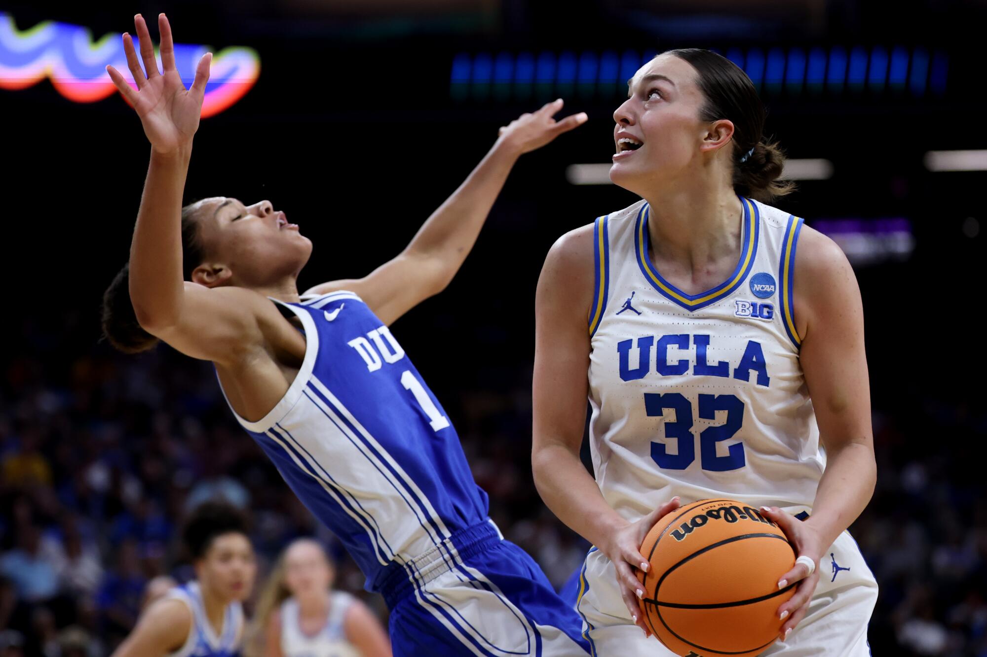 Duke forward Delaney Thomas, left, tries to draw a foul against UCLA forward Angela Dugalic during the first half Sunday.