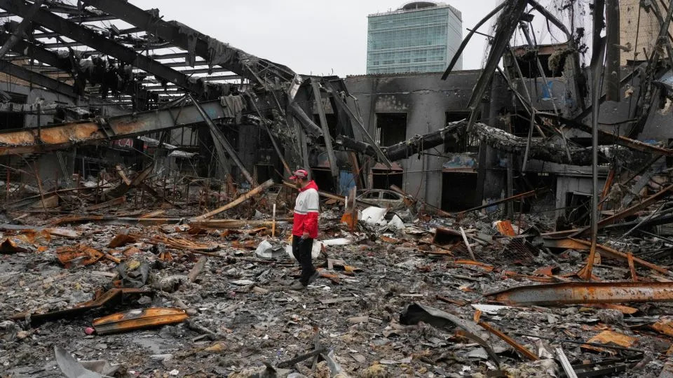 A member of the Iranian Red Crescent Society stands at Hypercar, an auto service center, amid damages which according to the company's officials were caused by strikes on March 1, in Tehran, Iran on March 28, 2026. - Vahid Salemi/AP