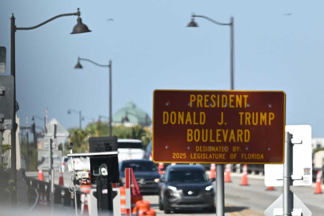 A sign designating the Donald J. Trump Boulevard is seen outside of the Mar-a-Lago resort in Palm Beach, Florida in