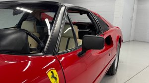 A close-up of a front portion of a 1979 Ferrari 308 GTS used in the early first season of filming for the 