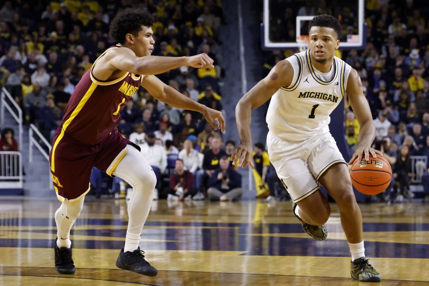Michigan guard Trey McKenney dribbles during a home game against Minnesota in February.