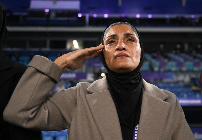 Iran coach Marziyeh Jafari salutes during the national anthem during the AFC Women's Asian Cup Group A match between Iran and Philippines at Gold Coast Stadium on the Gold Coast, Australia, March 8, 2026. AAP/via REUTERS ATTENTION EDITORS - THIS IMAGE WAS PROVIDED BY A THIRD PARTY. NO RESALES. NO ARCHIVE. AUSTRALIA OUT. NEW ZEALAND OUT. NO COMMERCIAL OR EDITORIAL SALES IN NEW ZEALAND. NO COMMERCIAL OR EDITORIAL SALES IN AUSTRALIA.