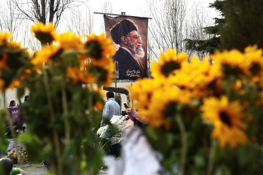 A banner of Iran's late Supreme Leader Ayatollah Ali Khamenei is displayed at Tajrish Bazaar on Thursday, ahead of Nowruz.