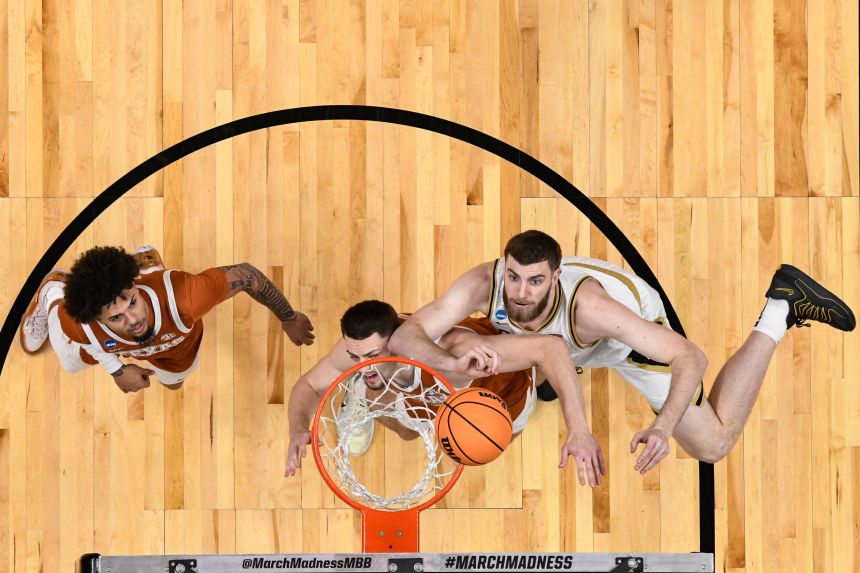 Purdue Boilermakers center Oscar Cluff shoots against the Texas Longhorns during a Sweet Sixteen game in San Jose, California, on Thursday.