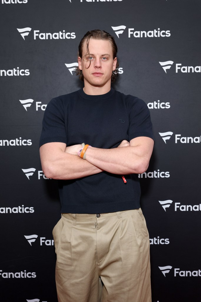 Joe Burrow standing with his arms crossed in front of a black backdrop with the Fanatics logo.