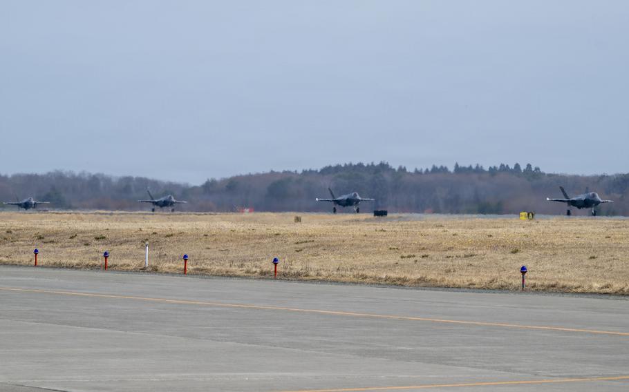 Four U.S. Air Force F-35A Lightning II aircraft taxi on the runway.